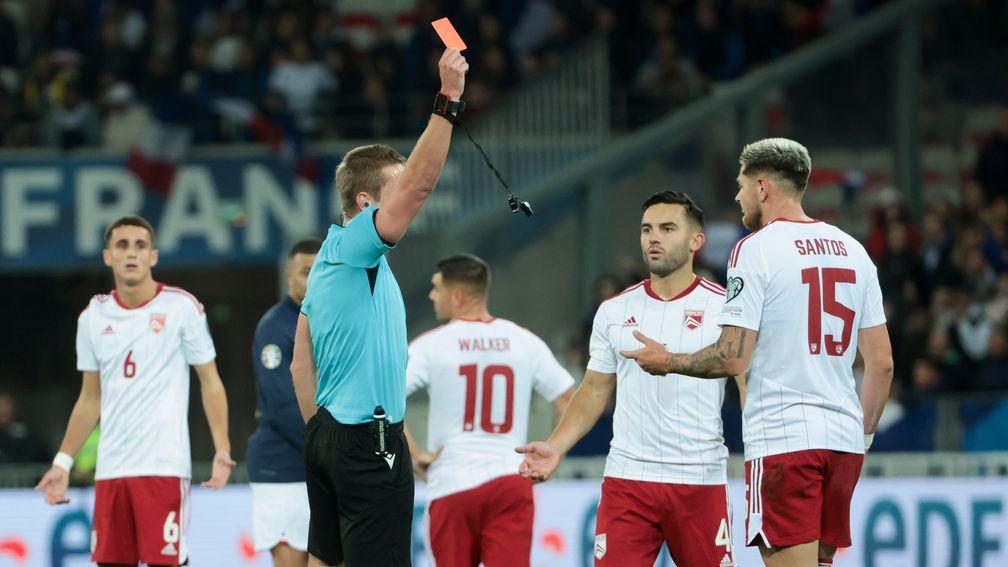 Gibraltar's Ethan Santos is shown a red card against France